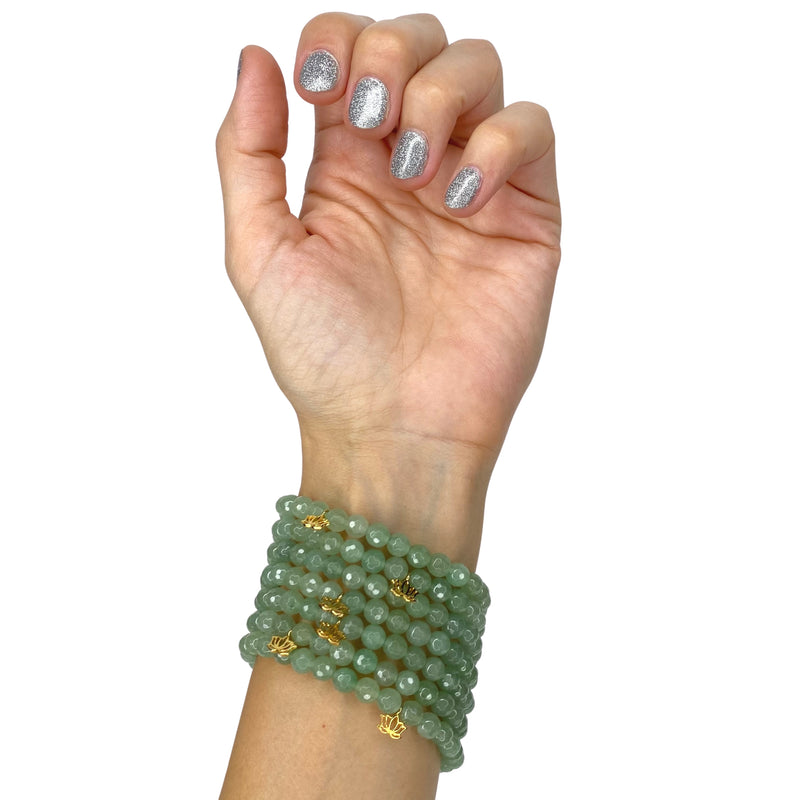 Hand with green aventurine bracelets